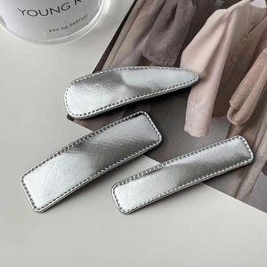 Three-piece set of minimalist silver leather hair clips in diverse geometric shapes