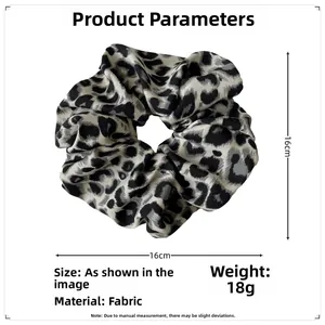 Detail view of large leopard print scrunchie showing 16cm diameter and fabric texture