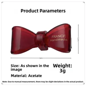 Detail view of 3cm red acetate bow hair clip with France Handmade gold engraving