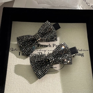Sparkling black bow hair clips with micro-rhinestones in a vintage jewelry display box