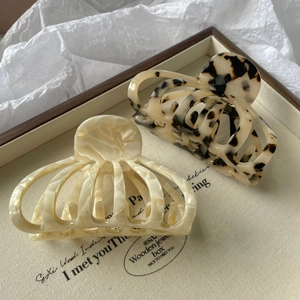 Pinces à cheveux en acétate marbré crème et écaille de tortue sur plateau en bois