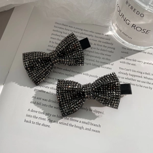 Elegant pair of black bow hair clips with shimmering rhinestones for stylish hair styling