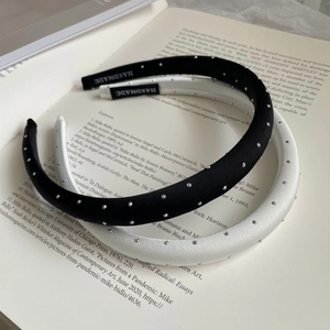 Detail view of handmade black and white sparkling headbands on a vintage book