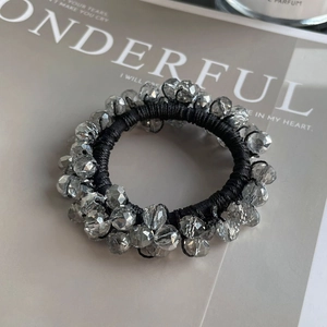 Close-up of handmade elastic hair tie with grey faceted crystal beads for women