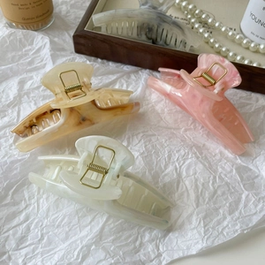 Three-piece large acetate hair claw clips with marble texture in cream and amber shades