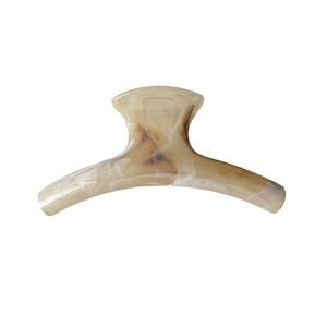 Large marble pattern claw clip with cream and amber swirls for elegant hair styling