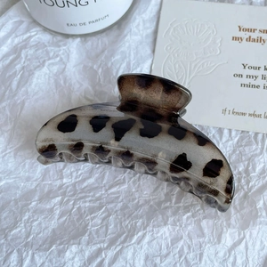 Vue macro détaillée d'une grande pince à cheveux léopard avec finition écaille de tortue