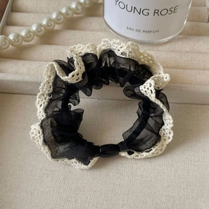 Lace mesh scrunchie with pearl details displayed in a luxury jewelry box