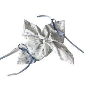 Cat print hair scrunchie with long light blue silk ribbon on white background
