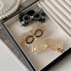 Trois pinces à cheveux élégantes avec nœuds en strass, coloris noir, champagne et crème