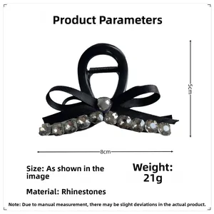 Detail view of grey rhinestone bow hair claw with 8cm length and pearl metal bead