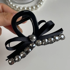 Elegant black bow hair claw clip with grey rhinestones and pearl accents for women