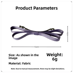 Detail view of purple fabric bow hair clip with dimensions thirteen by four centimeters