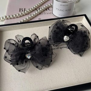 Polka dot tulle bow hair claw clip with heart rhinestone in a French romantic setting