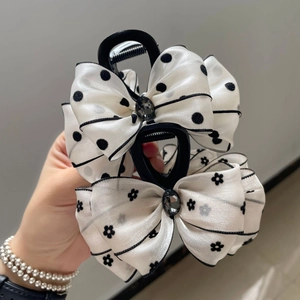 Polka dot and floral double-layered bow hair claws with elegant gemstone accents