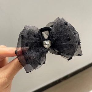 Elegant black polka dot tulle bow hair claw clip with a large heart shaped rhinestone