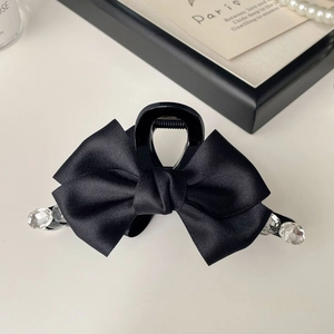 Detailed view of luxury black satin ribbon bow hair claw clip with crystal rhinestones