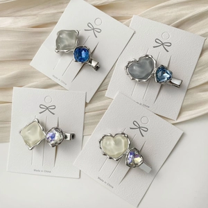 Chic 4-piece heart crystal hair clip set with blue and white stones on elegant satin
