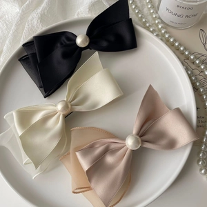 Elegant satin bow hair clips set with pearls in black, white, and apricot colors