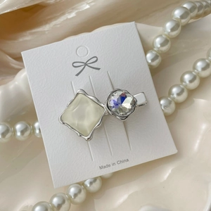 Close-up of elegant silver duckbill hair clip with crystal and resin stone detail