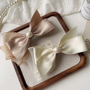 Elegant double-layered satin and organza bow hair clip with central pearl ornament