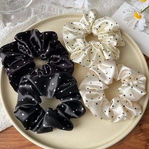 Set of four French satin polka dot hair scrunchies in classic black and white colors