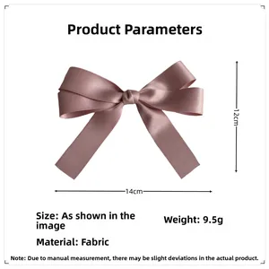 Detailed view of pink satin bow hairpin with dimensions 14cm width and 12cm height