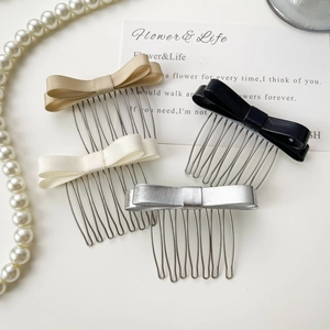Détail d'un lot de quatre peignes à cheveux élégants avec nœuds en satin, cuir et argent