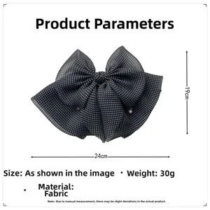 Detail view of the black and white polka dot bow hair clip showing 24cm by 19cm size