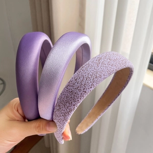 Detailed view of 3-piece purple satin padded headband set with soft textures