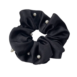 Elegant black satin hair scrunchie with faux pearl accents and a glossy silk finish