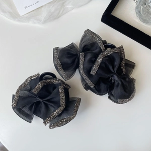 Elegant pair of black bow hair claws with satin organza and crystal rhinestones