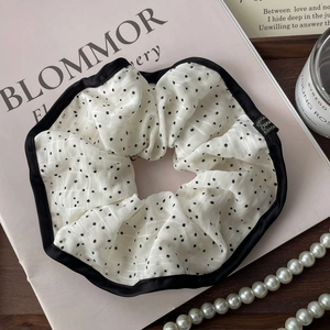 French style white polka dot scrunchie with black satin trim and luxury brand tag