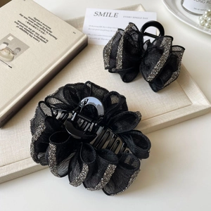 Detail of elegant black mesh bow hair claws with sparkling silver rhinestone trim set