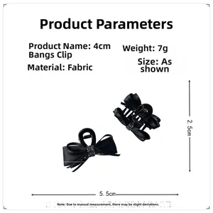 Detailed view of two black ribbon bow hair clips with rhinestone centers and 5.5cm size