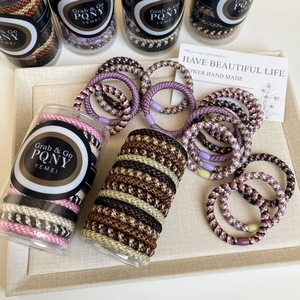 Multi-colored braided high elasticity hair tie set in a transparent storage cylinder