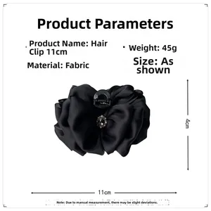 Detail view of 11cm black satin bow hair claw clip with vintage jewelry embellishment