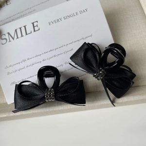 Set of two black satin ribbon bow hair claws with sparkling rhinestones for women