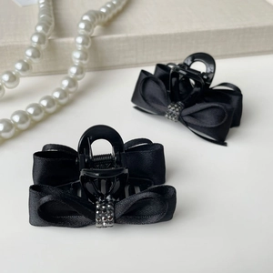 Elegant black satin bow hair clips with sparkling crystal center for women, set of two