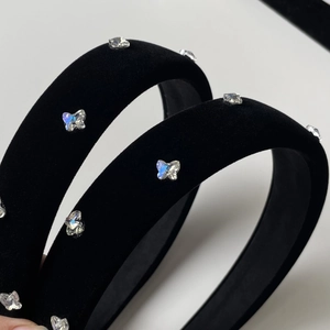 Detailed macro view of black velvet headband featuring sparkling iridescent crystal butterflies
