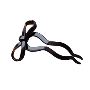 Elegant tortoiseshell bow hair fork with high-gloss finish for ballet style hairstyles