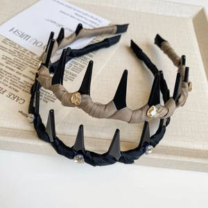 Close-up of fabric wrapped headbands with rhinestones and built-in hair combs in two colors