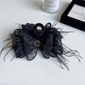 Elegant black polka dot tulle hair claw clip with feather trim and center rhinestone