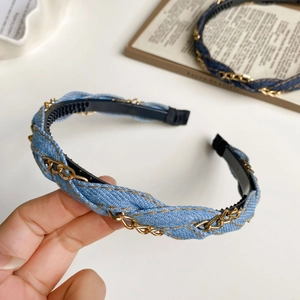 Detail of blue denim headband featuring woven gold metal chain and anti-slip inner teeth