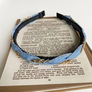 Detail of light blue denim fabric headband with gold chain and non-slip inner teeth