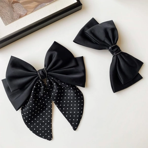 Elegant black silk bow hair clips set with polka dots and sparkling rhinestone center