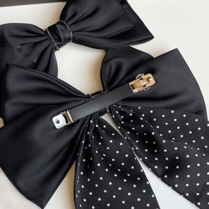 Elegant black satin bow hair clip with crystal rhinestone and polka dot ribbon detail