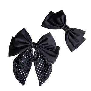 Elegant black satin bow hair clips with white polka dots and sparkling rhinestone center