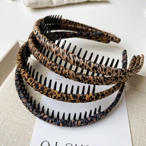 Detail of leopard and tiger print headbands showing non-slip inner comb and silk fabric