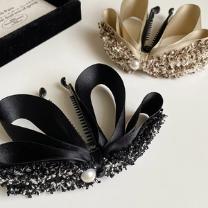 Elegant tweed and satin bow banana hair clips with pearl detail in black and champagne